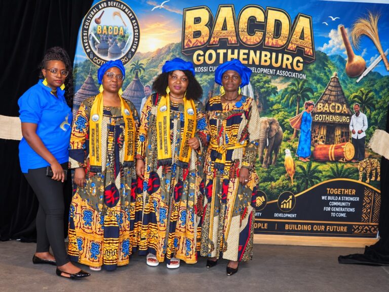 Guests in traditional attire beside the BACDA Gothenburg launch backdrop