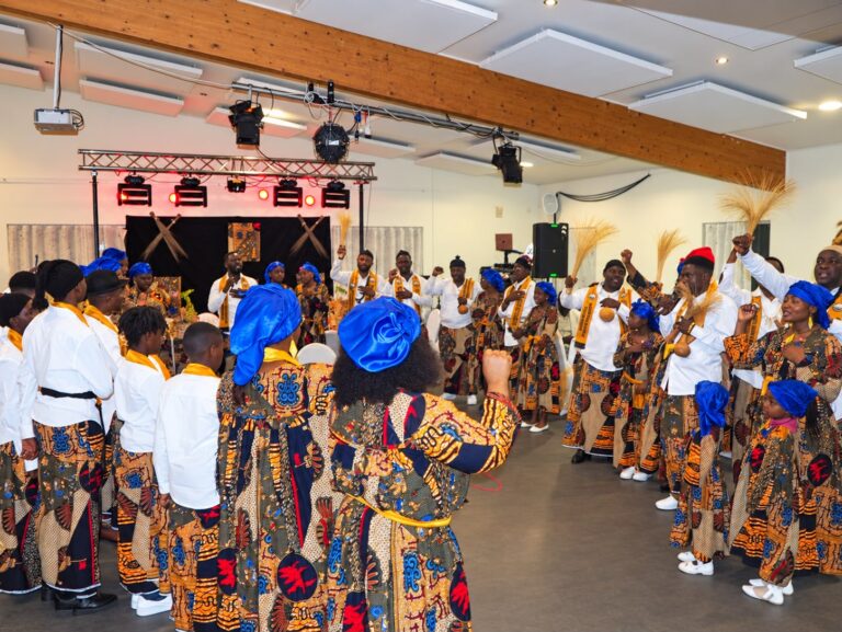 Community members dancing together in the celebration hall