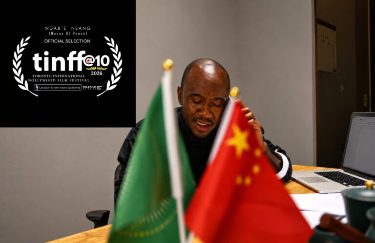 Administrator seated behind a desk with flags