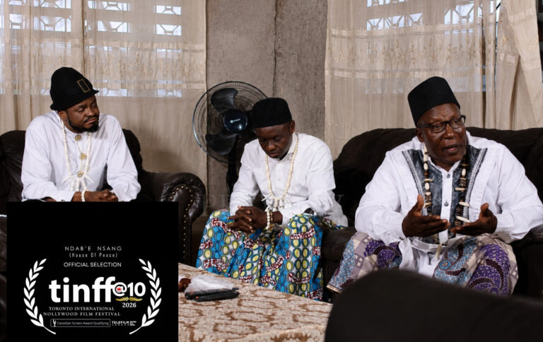 Elders in white attire seated in discussion